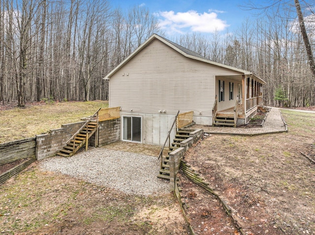 back of house with stairway and a wooden deck