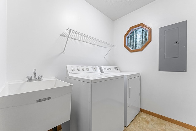 laundry room with a sink, independent washer and dryer, electric panel, laundry area, and baseboards