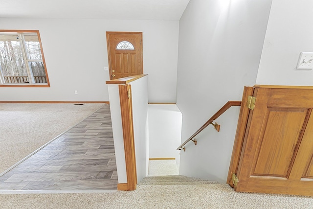 stairs featuring plenty of natural light, carpet flooring, and baseboards