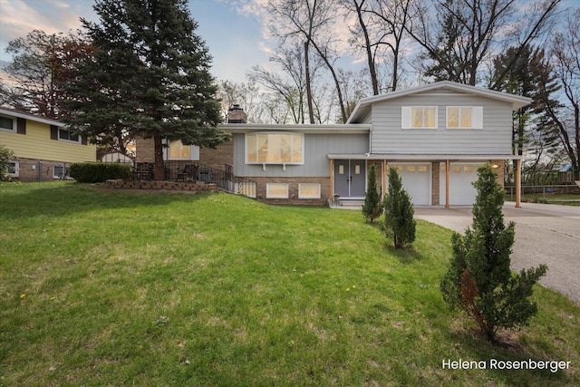 1456 54th St SE, Grand Rapids, MI 49508 - split level home featuring a chimney, a garage, a front yard, and concrete driveway
