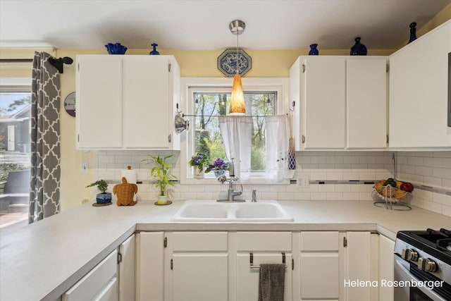 1456 54th St SE, Grand Rapids, MI 49508 - kitchen featuring a sink, light countertops, tasteful backsplash, and white cabinetry
