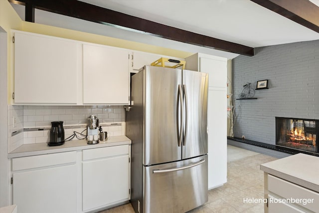 1456 54th St SE, Grand Rapids, MI 49508 - kitchen with freestanding refrigerator, tasteful backsplash, white cabinets, and light countertops