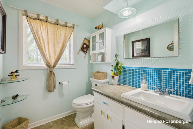 1456 54th St SE, Grand Rapids, MI 49508 - bathroom featuring toilet, baseboards, and vanity