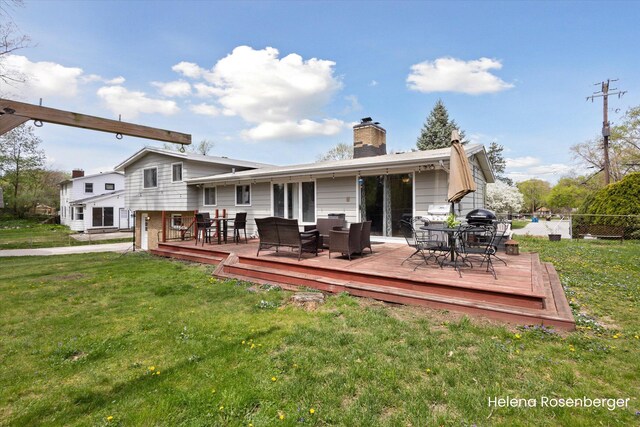 1456 54th St SE, Grand Rapids, MI 49508 - back of property with a yard, a deck, a chimney, and outdoor dining space