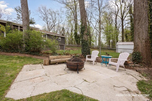 1456 54th St SE, Grand Rapids, MI 49508 - view of patio / terrace featuring an outdoor fire pit, fence, and an outbuilding