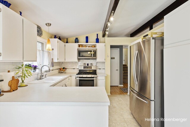 1456 54th St SE, Grand Rapids, MI 49508 - kitchen featuring backsplash, a sink, light countertops, vaulted ceiling with beams, and stainless steel appliances