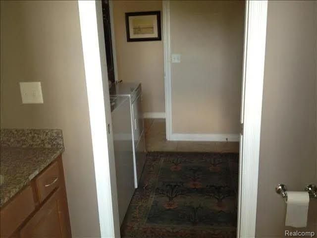 14922 Wildwood Dr, Monroe, MI 48161 - laundry room with tile patterned floors, laundry area, and washing machine and dryer