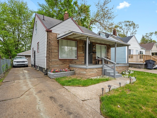 19400 Dwyer St, Detroit, MI 48234 - bungalow-style home featuring a chimney, a porch, a shingled roof, a front lawn, and stone siding