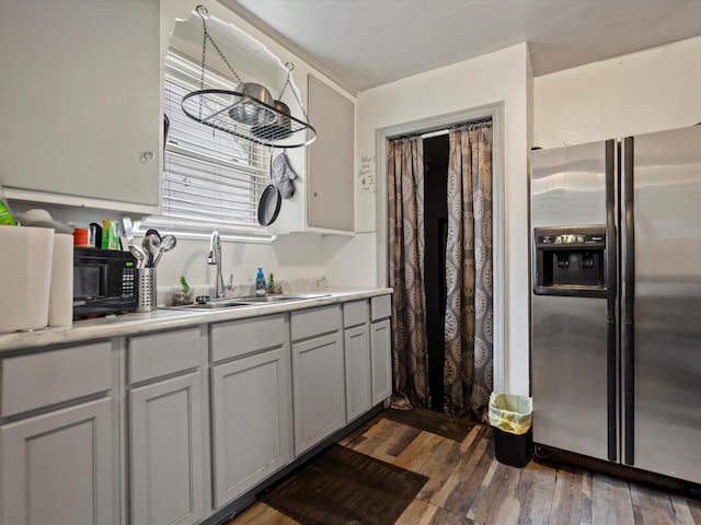 19400 Dwyer St, Detroit, MI 48234 - kitchen featuring stainless steel fridge, a sink, light countertops, dark wood-style flooring, and black microwave