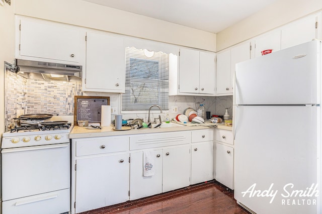 3817 Boone Ave SW, Wyoming, MI 49519 - kitchen featuring white appliances, under cabinet range hood, light countertops, white cabinets, and a sink