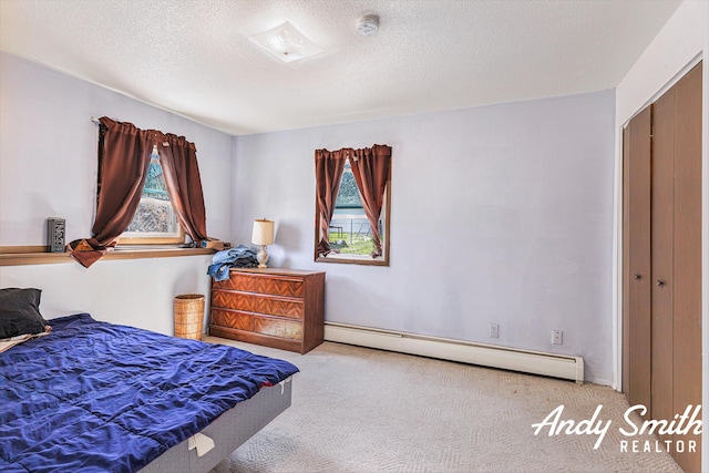 3817 Boone Ave SW, Wyoming, MI 49519 - carpeted bedroom with baseboard heating and a textured ceiling