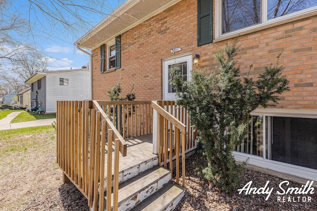 3817 Boone Ave SW, Wyoming, MI 49519 - view of exterior entry featuring a deck and brick siding