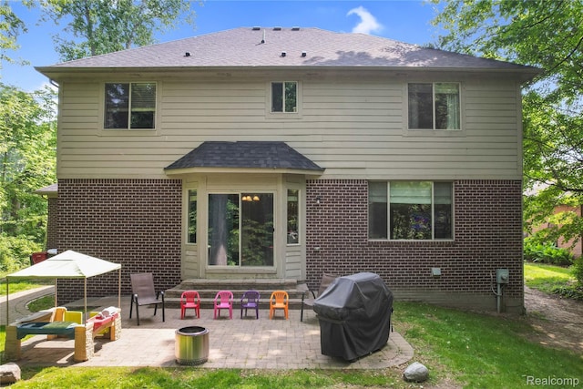 50477 Edith St, Chesterfield, MI 48047 - rear view of house featuring a patio, brick siding, and roof with shingles