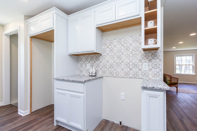 kitchen featuring tasteful backsplash, light stone counters, dark wood-style flooring, and recessed lighting
