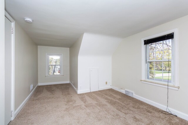 bonus room with visible vents, carpet floors, and baseboards