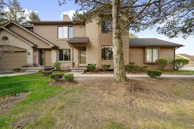29691 Sierra Pointe Cir, Farmington Hills, MI 48331 - view of front facade featuring brick siding, an attached garage, roof with shingles, and a chimney