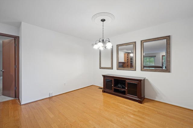 29691 Sierra Pointe Cir, Farmington Hills, MI 48331 - unfurnished dining area with baseboards, an inviting chandelier, and wood finished floors
