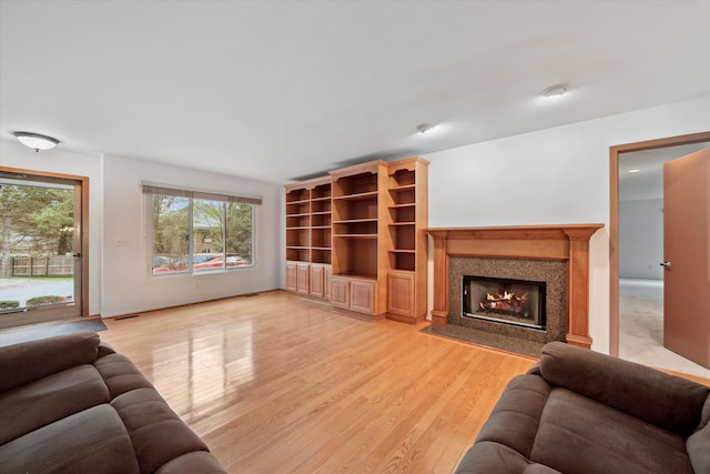 29691 Sierra Pointe Cir, Farmington Hills, MI 48331 - living room featuring visible vents, a fireplace with flush hearth, and light wood finished floors