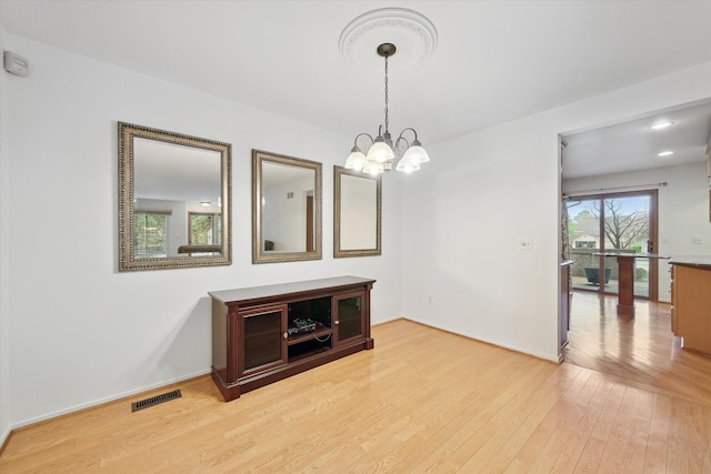 29691 Sierra Pointe Cir, Farmington Hills, MI 48331 - unfurnished dining area featuring baseboards, visible vents, light wood-type flooring, and a notable chandelier