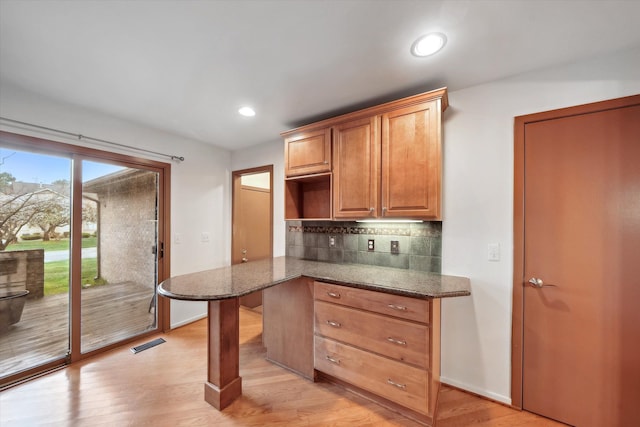 29691 Sierra Pointe Cir, Farmington Hills, MI 48331 - kitchen with dark stone counters, baseboards, visible vents, and decorative backsplash