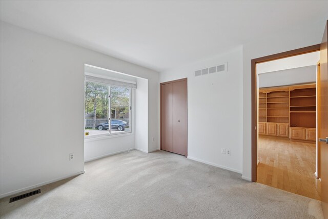 29691 Sierra Pointe Cir, Farmington Hills, MI 48331 - unfurnished bedroom with baseboards, light carpet, and visible vents