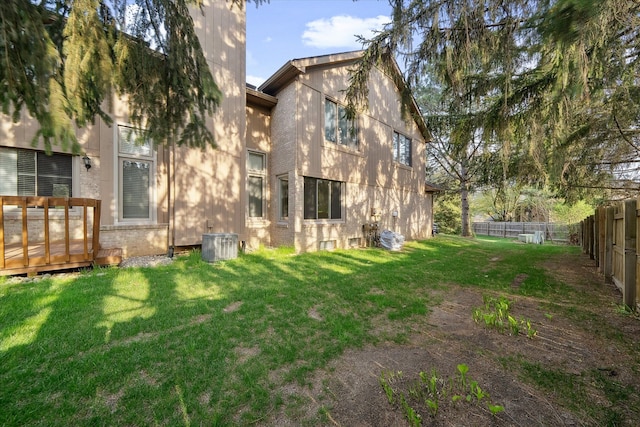 29691 Sierra Pointe Cir, Farmington Hills, MI 48331 - rear view of property with a fenced backyard, a lawn, and central AC
