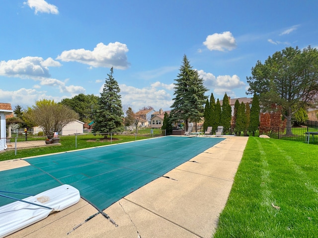 view of swimming pool featuring a fenced in pool, fence, and a yard