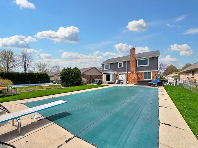 view of swimming pool with fence, a lawn, a patio, and a fenced in pool