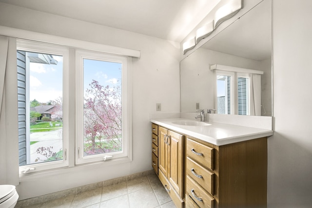 bathroom featuring toilet, a wealth of natural light, and vanity