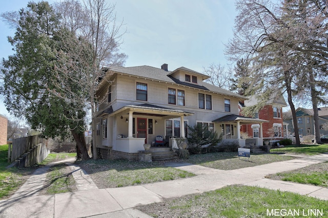 186 W 12th St, Holland, MI 49423 - american foursquare style home featuring covered porch, fence, and a chimney