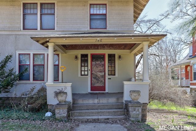 186 W 12th St, Holland, MI 49423 - property entrance with stucco siding and a porch