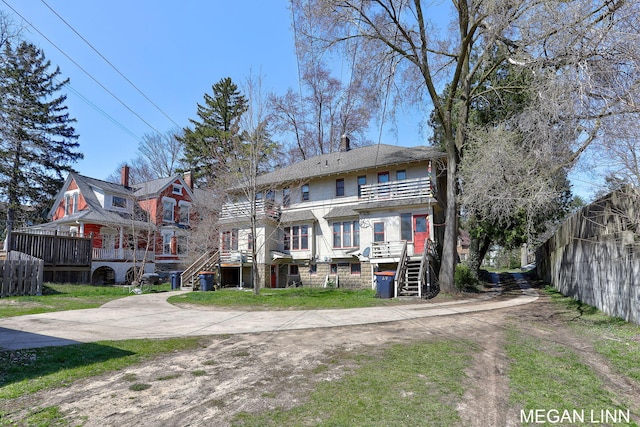 186 W 12th St, Holland, MI 49423 - rear view of house with stairs, fence, and a balcony