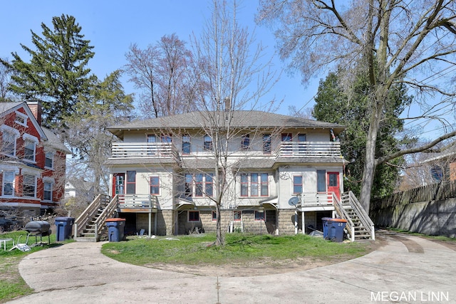 186 W 12th St, Holland, MI 49423 - exterior space with stairs, a balcony, and fence