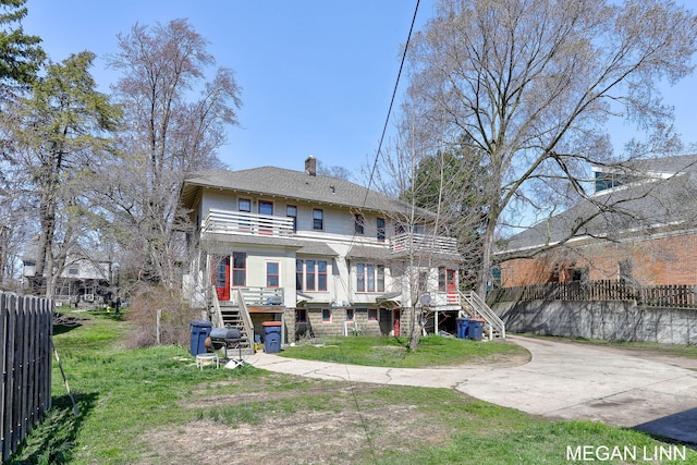 186 W 12th St, Holland, MI 49423 - back of property featuring fence, a chimney, stairs, and a balcony