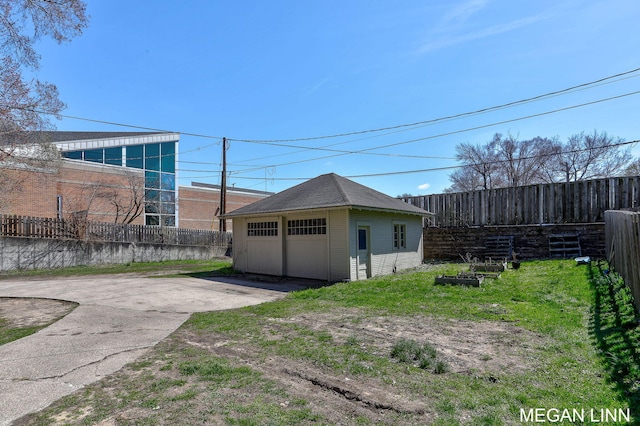186 W 12th St, Holland, MI 49423 - exterior space featuring a garage, fence, and an outbuilding