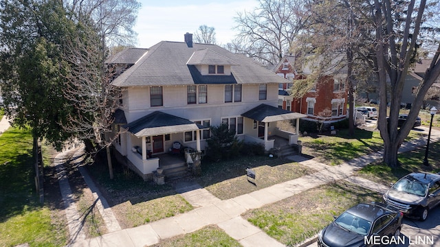 186 W 12th St, Holland, MI 49423 - view of front of property featuring roof with shingles, a chimney, and a porch