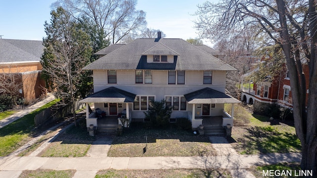 186 W 12th St, Holland, MI 49423 - american foursquare style home featuring a shingled roof and covered porch