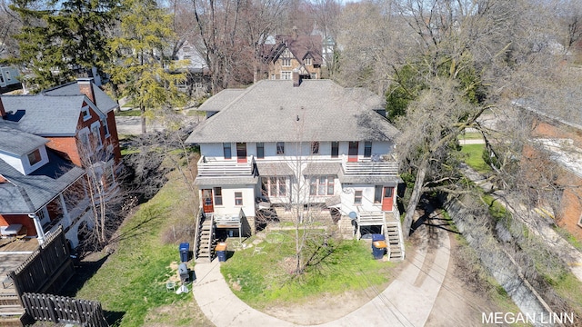 186 W 12th St, Holland, MI 49423 - rear view of property featuring fence, stairway, a balcony, and a shingled roof