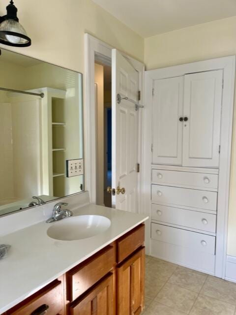 186 W 12th St, Holland, MI 49423 - bathroom featuring walk in shower, tile patterned flooring, and vanity