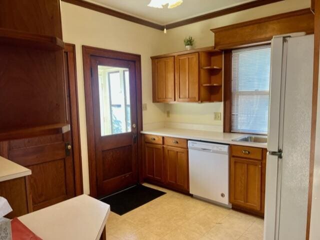 186 W 12th St, Holland, MI 49423 - kitchen featuring light countertops, brown cabinets, and white appliances