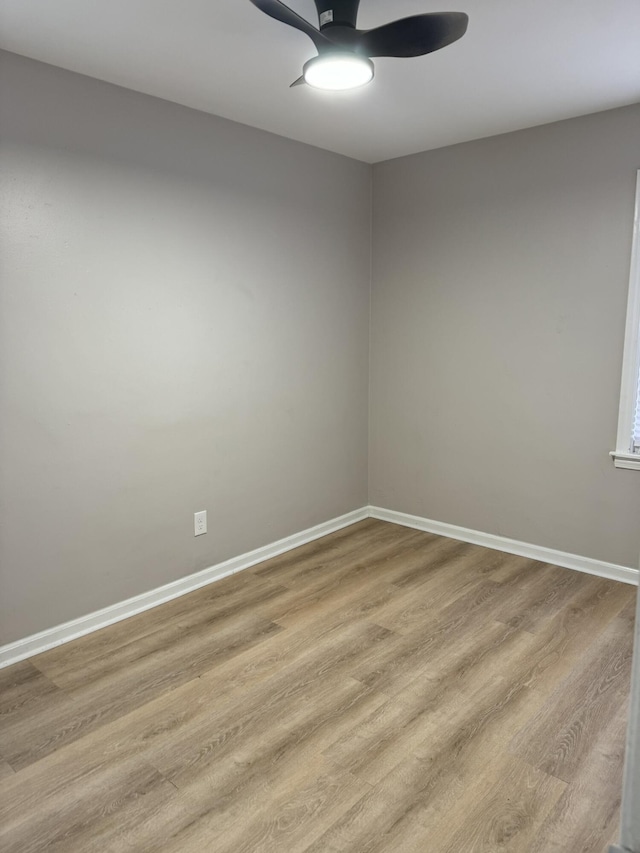 unfurnished room featuring wood finished floors, ceiling fan, and baseboards