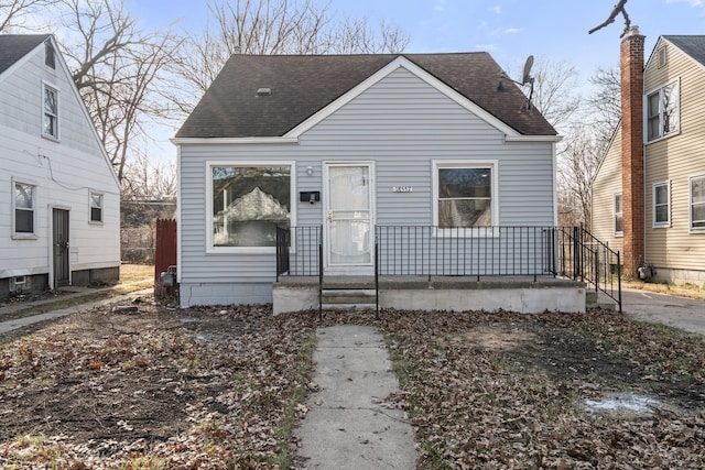 view of front of home with covered porch and a shingled roof