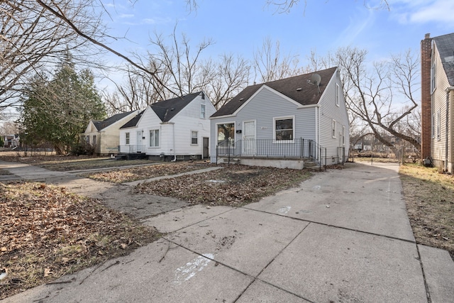 view of front of home with driveway and a shingled roof