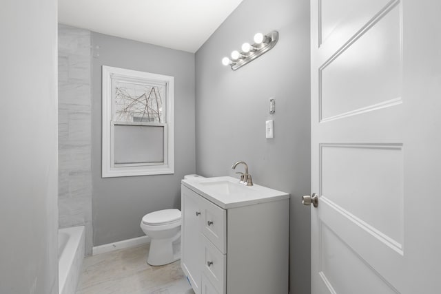 full bathroom featuring vanity, a washtub, toilet, a shower, and baseboards