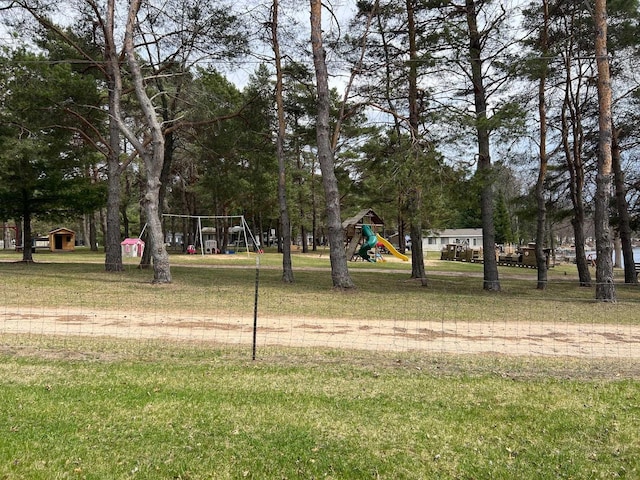 view of home's community with playground community and a yard