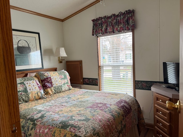 bedroom with ornamental molding and vaulted ceiling