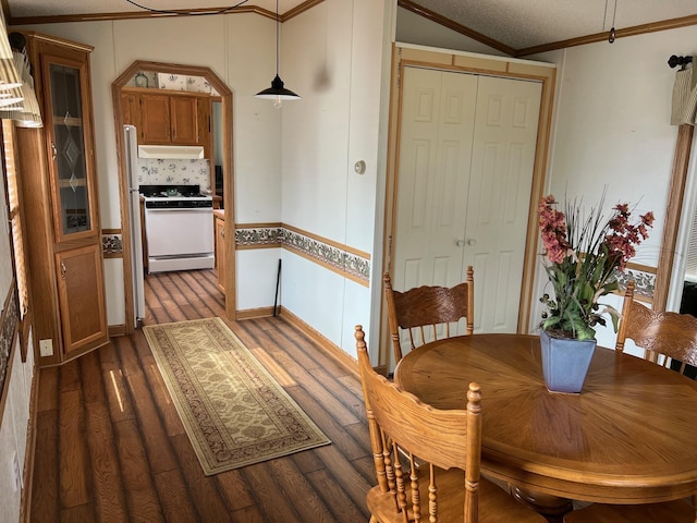 dining area with crown molding and dark wood-style floors