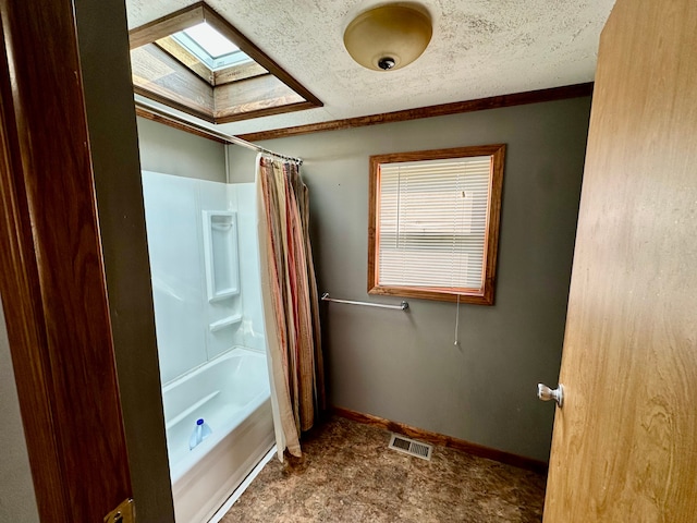 1088 Kern Rd, Fowlerville, MI 48836 - bathroom with a skylight, shower / bathtub combination with curtain, and baseboards