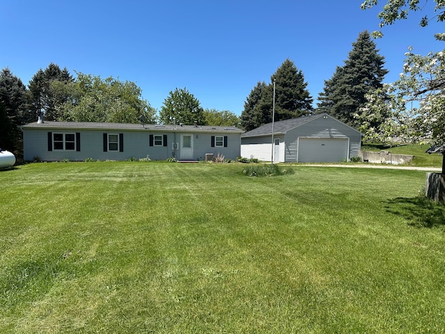 1088 Kern Rd, Fowlerville, MI 48836 - view of front of property featuring a front yard, an outbuilding, and a detached garage
