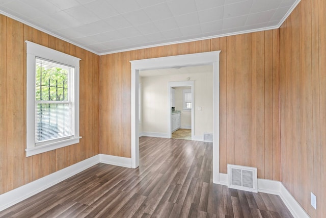203 E Stewart Ave, Flint, MI 48505 - unfurnished room with dark wood-style flooring, ornamental molding, wood walls, and baseboards